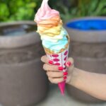 selective focus photography of person holding ice cream